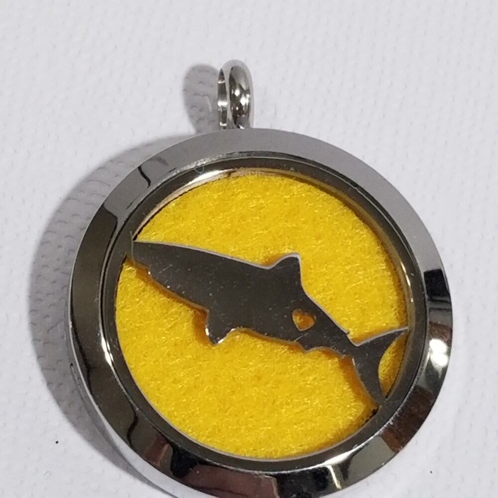 large pendant with Always remember on the back and a shark